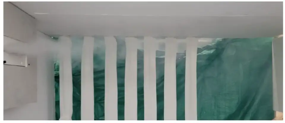 Figure 2: Image of a fog test showing supply air stream flowing along ceiling and being diluted as it mixes with room air.